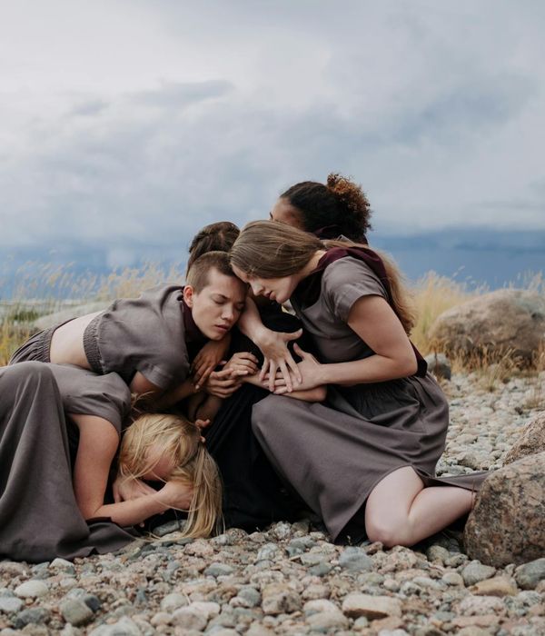 Woman performing a fluid, gentle movement in a calm environment.